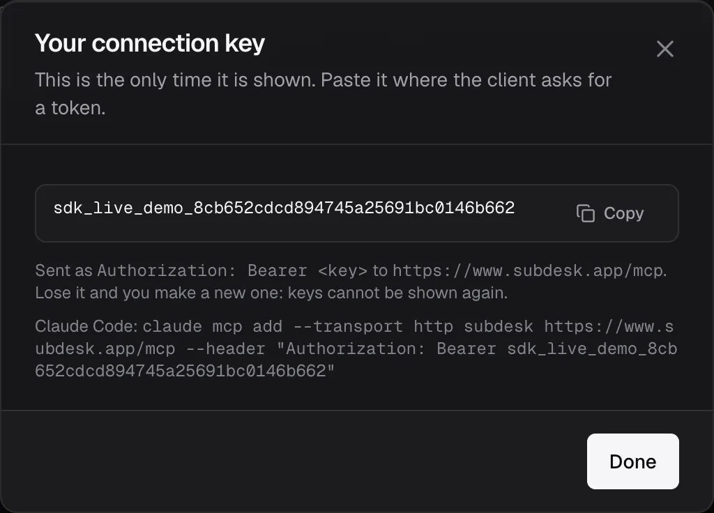 The Your connection key dialog, showing the key once with a Copy button and the Claude Code command